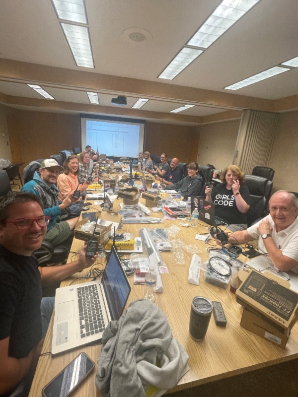 A group of teachers smiling at a table inside ARRL headquarters from a Teachers Institute session.