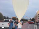 Ron Meadows walks the balloon out for launch.This was after sunset to limit UV exposure. Don Ferguson, KD6IRE (left in blue jacket) carries the payload. [Bob Snelgrove, KG6TBY, Photo]
